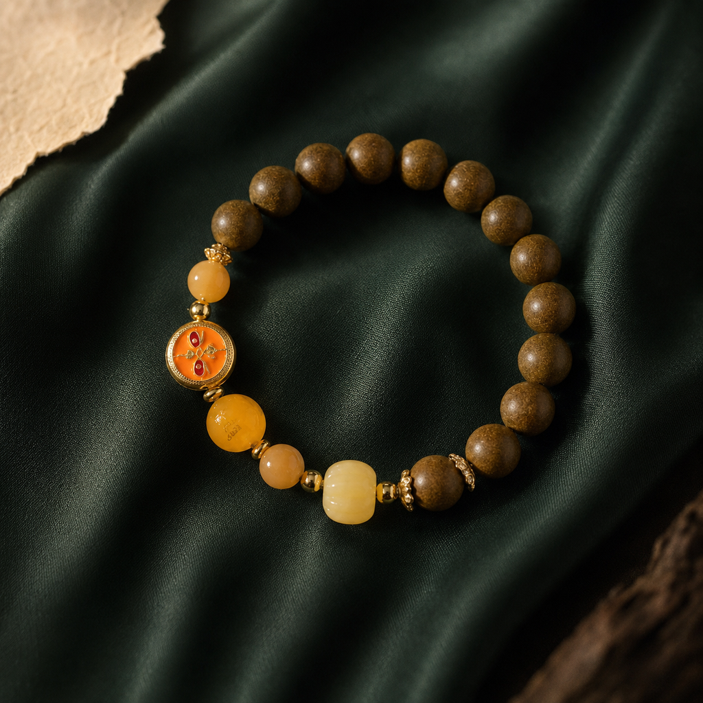 Brown He Xiang bracelet with warm yellow stone beads, an orange glass feature element and gold-toned spacers