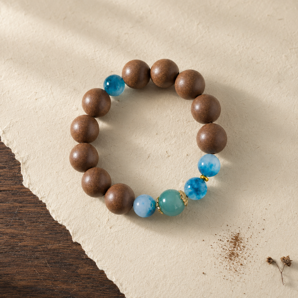 Brown He Xiang bracelet with water-blue chalcedony accents, gold-toned details and a blue jade-style bead