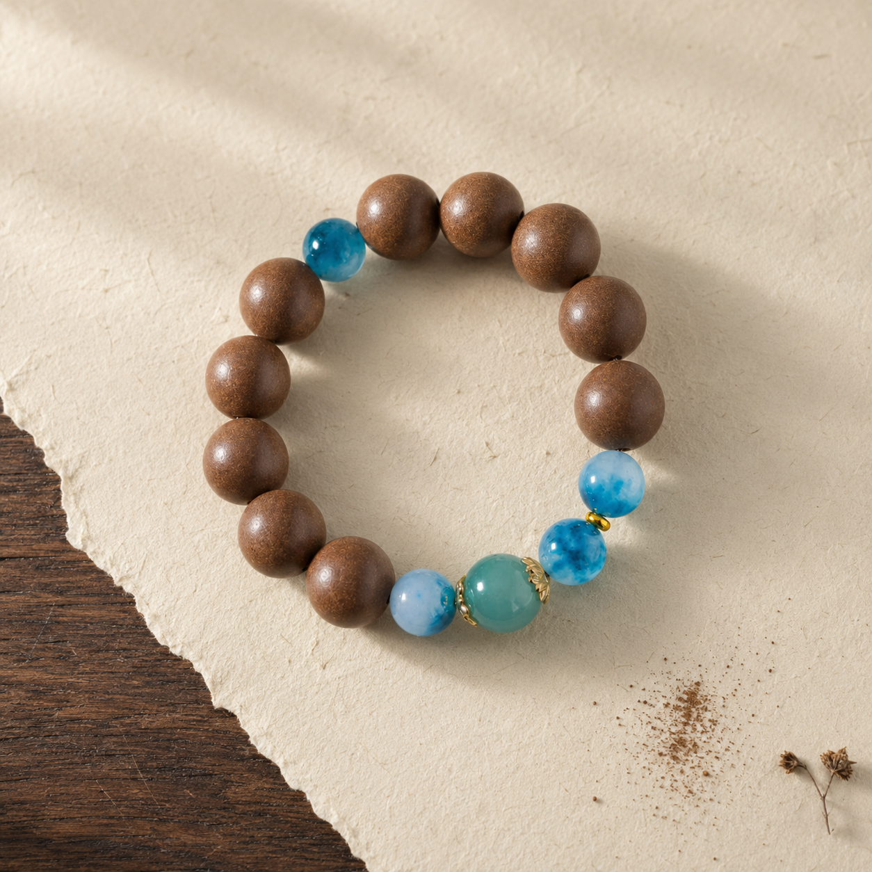 Brown He Xiang bracelet with water-blue chalcedony accents, gold-toned details and a blue jade-style bead