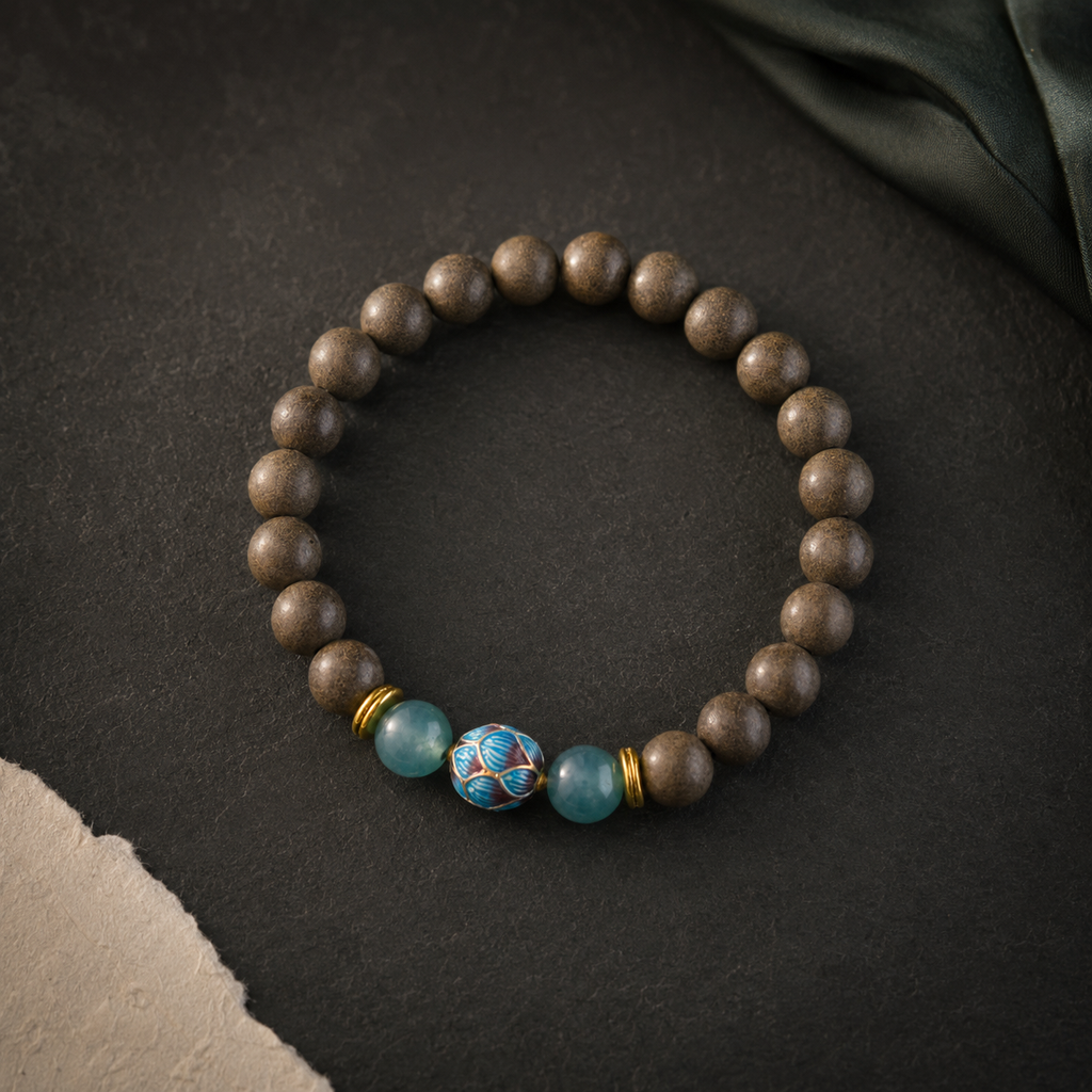 Brown He Xiang bracelet with two blue-green glass beads, a blue cloisonné floral bead and gold-toned spacers